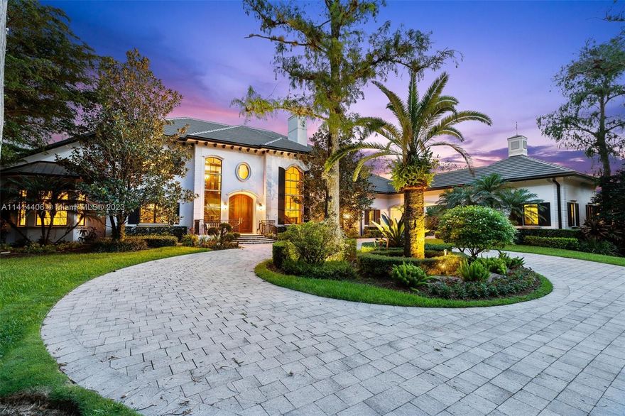 The moment you pass through the gated entrance & approach this private residence, you are greeted by elegant French Colonial architecture nestled in a wonderland of cypress & palm. Situated on 2 acres, this property offers luxury, recreation & plenty of space while remaining warm & inviting. A tasteful blend of marble & dark wood floors, coffered ceilings and custom millwork stretch throughout the spacious interior. The newly-renovated kitchen features a top of the line custom cabinetry, quartz counters, Wolf industrial range, Sub-Zero refrigeration & Miele coffee machine. Additional features include brand new roof, whole house generator, water purification, city water & sewer, impact windows, office, gym, 2 gas fireplaces, 4 car garage, billiard room, outdoor kitchen & resort style pool.