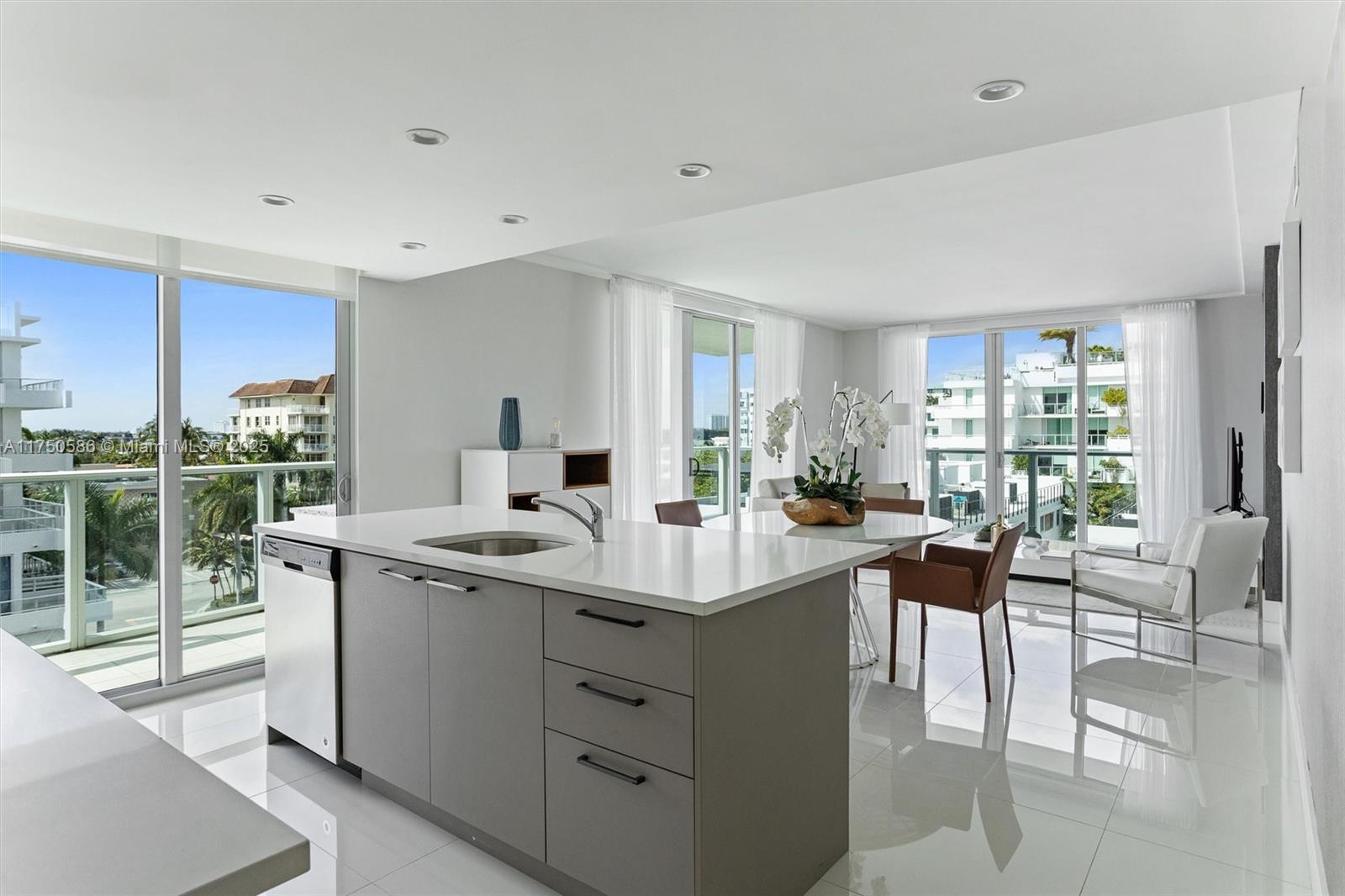 This stunning corner unit features a sleek modern design with two bedrooms—including a luxurious master suite—and a versatile den that converts into a second bedroom. Designed by renowned interior designer Paola Pla, it showcases high-quality materials and refined finishes, balancing elegance and comfort. Floor-to-ceiling windows flood the space with natural light. The expansive wraparound balcony offers a private retreat with a gourmet entertaining area, perfect for al fresco dining. Just steps from Bal Harbour Shops, dining, and entertainment, it’s less than a mile from the beach and near a top Miami school. Amenities include a rooftop pool with panoramic views, fitness center, ample storage space, and two parking spaces with elevator access.