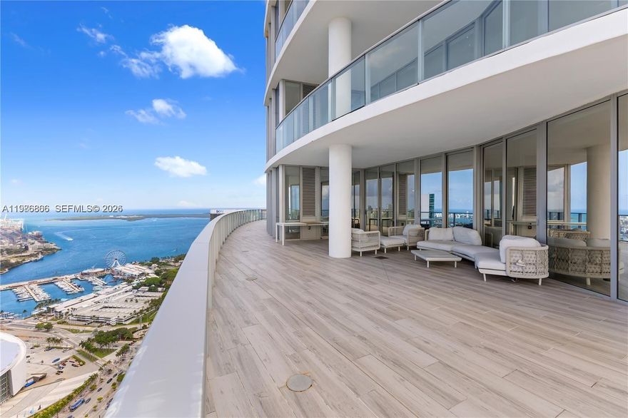 Experience the pinnacle of elevated living from the 52nd floor of the world-renowned Paramount Miami Worldcenter. This masterpiece features 4 bedrooms and 5 full bathrooms, fully furnished and curated by the legendary interior designer Adriana Hoyos. The expansive floor plan boasts soaring 10-foot ceilings and private elevator access that opens into a grand foyer, framing breathtaking, unobstructed panoramic views of Biscayne Bay, the Atlantic Ocean, and the shimmering Miami skyline. The defining feature of this residence is its massive, record-breaking 2,500-square-foot wrap-around terrace—the largest in the building—offering an unparalleled private outdoor sanctuary for entertaining against a backdrop of endless blue horizons. Residents enjoy a chef’s kitchen equipped with premium Sub-Zero and Wolf appliances, 3 assigned parking spaces, and access to the most comprehensive amenity package in the world, including tennis courts, multiple resort-style pools, golf simulator, rooftop observatory, indoor basketball court, and a spa that rivals your favorite weekend escape. Perfectly positioned in the heart of downtown, this high-floor sanctuary serves as a true sky-mansion, providing a lifestyle of absolute privacy and prestige. It is a legacy property designed for the discerning buyer who demands the very best in Miami's most ambitious urban core.