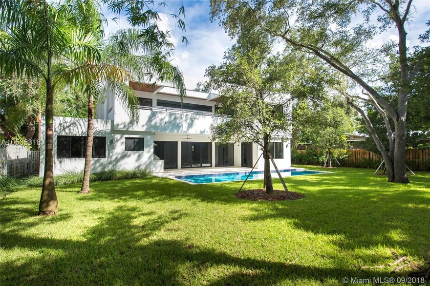 Spectacular, Tropical Modern home on an ultra-private, oak-canopied cul-de-sac in prime North Grove location.  Rarely available features: ~12,000 SF gated lot w/ expansive back yard, situated high on coral ridge (19 ft. above sea level), 1st floor guest suite + housekeeper’s rm., Italian porcelain/European White Oak flooring & upstairs loft  w/ wet bar. Dramatic double-height foyer opens to light-filled formal living, dining & family rooms overlooking the tranquil garden, lap pool and deep covered terrace w/summer kitchen. Stunning Italkraft kitchen with Subzero/ Wolf appliances, white quartz countertops & 6-burner gas range. Luxurious master suite opens to large terrace w/ tree-top views & spa-like, Carrara marble master bath. Close to the Grove village and bayront parks & marinas.