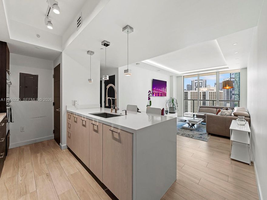 $75,000 in Upgrades. Turnkey luxury,designer-remodeled 1-Bedroom in 500 Brickell East/ NO ASSESSMENTS. Every detail of this home has been meticulously upgraded with premium finishes. Blonde wood-look porcelain tiles runs throughout and carry into the oversized balcony. The open concept living space is elevated with WAC recessed lighting, dropped ceiling cove lighting, and direct LED fixtures. A full size Samsung front load washer and dryer. The spa-inspired bathroom, with marble-style wall finishes, all new plumbing, separate tub and shower w/ body jets, plus ceiling mounted tub filler. The bedroom features an elegant accent wallpapered wall and Lutron Smart lighting, fully controlled from the phone. Set in the heart of Brickell, steps from fine dining, entertainment, and transportation.