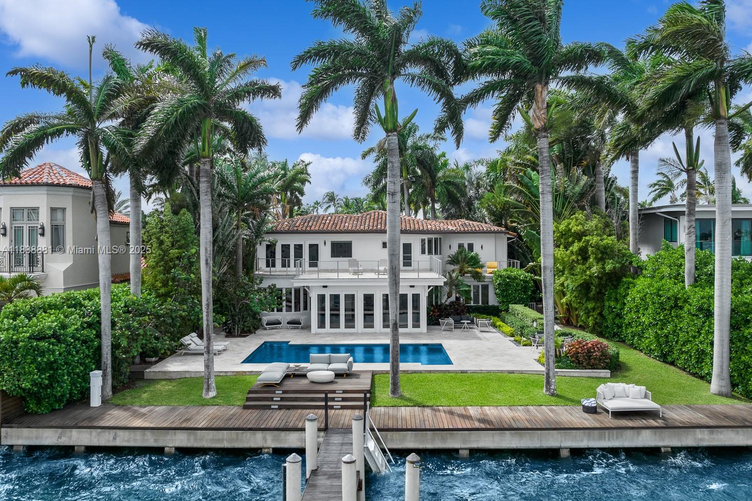 Step Inside With Me! Introducing 315 E Rivo Alto Drive on the Venetian Islands. Offering charming curb appeal, it greets with an idyllic courtyard surrounded by lush greenery. Featuring 5 bedrooms, this classic home showcases lovely natural light and water vistas throughout its many living areas. An iron staircase adds character leading to the second level with hardwood floors and 3 upper suites. Take in serene sunrises and ocean breezes from the primary suite featuring walk-in closet and spacious bath with dual vanities and a soaking tub. An expansive backyard is elevated with a beautiful pool, outdoor shower, dining and lounging areas, and beloved Eastern views along 90 feet of water frontage. This rare lot-and-a-half property is just minutes from Sunset Harbour and The Standard.