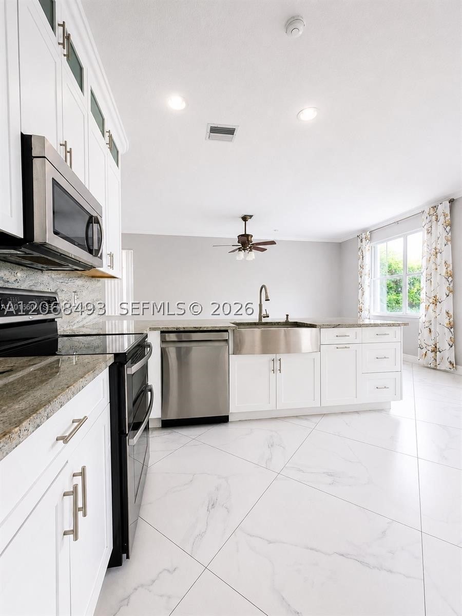 Photo of 963 Falling Water Rd, Weston, FL 33326 (MLS # A12068493)