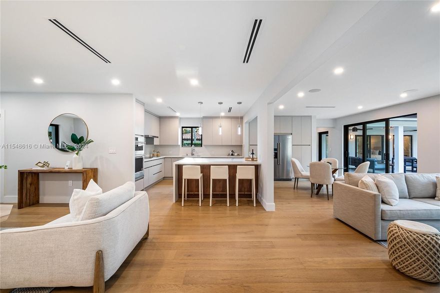 This impressive single-family home in Coral Gables sits on a spacious 10,500 square-foot lot, conveniently located near Riviera Country Club and Merrick Park for shopping and dining. Recently renovated to a high standard, the property features premium finishes and upgrades including a new roof, PVC plumbing, updated electrical and mechanical systems, as well as impact-resistant windows and doors. Step outside to the expansive covered terrace overlooking the large backyard, providing the perfect setting for outdoor relaxation and enjoyment.