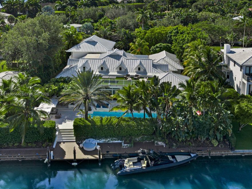 Step Inside With Me! This Coastal Contemporary waterfront retreat in the private Bay Point community greets with 21' ceilings and abundant natural light. The recently renovated residence delivers the ideal open layout with vaulted ceilings, 6 bedrooms, media room, club room, and a chef-caliber gourmet kitchen. The luxe primary suite impresses with dual dressing rooms, morning bar, and Carrara marble spa bath. The outdoor experience is pure resort living—lush landscaping frames an oversized pool, jacuzzi, sauna, and a rooftop terrace for sunset entertaining. This made-for-a-boater home boasts 120 FT of premium water frontage, dock, and boat lifts. Positioned on a rare 20,124 Sq.ft lot, this offering is completed by 2-car garage/gym, generator, and motor court.