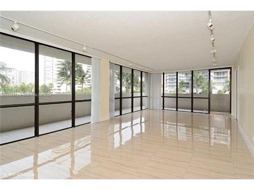 CROSS THE STREET AND YOU ARE ON THE BEACH ON  A1A!  TOTALLY UPDATED CORNER WRAP UNIT 2 BEDROOMS PLUS DEN WITH FRENCH DOORS CAN BE 3RD BDRM. PORCELAIN FLOORS THROUGHOUT,  TOP OF THE LINE MODERN FINISHES. 5-STAR AMENITIES - MODERN GYM, POOL TENNIS AND BBQ ON THE INTRACOASTAL SIDE, RESORT LIVING ALL YEAR ROUND, WITH   GUARD GATE AND LOBBY ATTENDANT INCLUDED.    MINUTES TO AVENTURA MALL AND BAL HARBOUR, CASINOS, EXPRESSWAYS AND AIRPORTS. INVESTORS' DREAM: EXCELLENT LONG TERM TENANTS PAYING $3,000 A MONTH LEASE UNTIL JULY 31, 2025.  SHOWINGS WITH ADVANCE NOTICE. DO NOT DISTURB THE TENANTS . VERY LOW HOA FEES , BOARD MANAGED BUILDING WITH OUTSTANDING MANAGEMENT AND FINANCIALS.