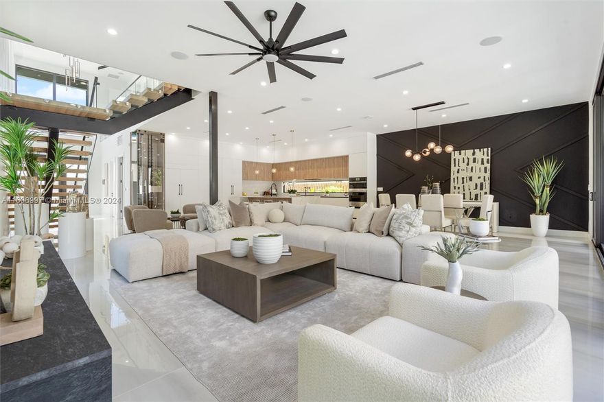 FULLY FURNISHED Property (negotiable). The West Coast Contemporary meets East Coast Luxury—an amazing allure of abundant natural light. Opulent fixtures redefine modern luxury at an enticing price point. Marvel at the 22ft ceilings upon entry, a floating staircase, and artful tempered glass railings gracing the upstairs. The living area is expansive, this home boasts over 3400 sq. ft of living and 4300 total sq ft, perfect for seamless dining and entertaining. The open-concept kitchen flaunts ample counter-prep space and clever storage solutions. A choreographed reveal of sliding windows brings an indoor-outdoor paradise, showcasing a covered summer kitchen and an alluring infinity-edge heated saltwater pool. COMPLETE AND READY TO MOVE IN, in the heart of Victoria Park.