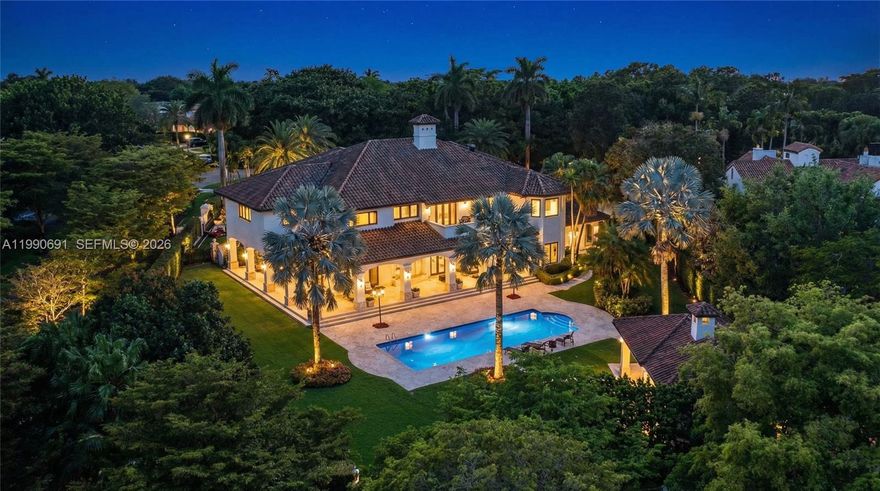 Elegant Mediterranean estate on a prime corner lot in Coral Gables, offering 8,956 SF of living space on an expansive 43,732 SF lot with three separate entrances for ultimate privacy and convenience. This impressive residence features 7 bedrooms, 8 full bathrooms, and 3 half baths, along with a private office and a dedicated bar room designed for entertaining. Grand interiors are highlighted by soaring ceilings, a sweeping staircase, and expansive living areas, including two formal dining rooms. The primary suite is a true retreat, spanning approximately 1,300 SF with dual walk-in closets and a private balcony overlooking the pool and lush grounds.
Designed for seamless indoor-outdoor living, the home offers a stunning 180-degree covered terrace, a spacious backyard with a resort-style pool, and a gazebo complete with two bathrooms and a BBQ area—perfect for entertaining at scale. Additional features include a 4-car garage and timeless Mediterranean architecture throughout. A rare opportunity in one of Coral Gables’ most prestigious settings.
