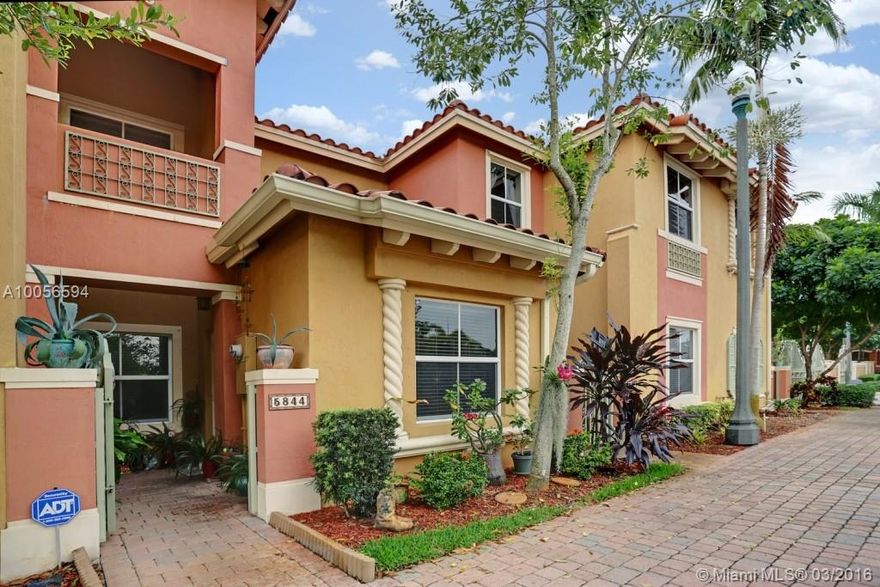 This townhouse in a quiet all ages gated community, features architecturally accented front door. Ceramic tile floors downstairs and carpeting upstairs, an all electric kitchen with pantry & 18 cubic foot refrigerator with an ice maker. Rain gutters on the exterior. There is a high efficiency air conditioner and an alarm system. This model features the 3rd bedroom as a den. There is a community pool and a tot lot.  Located close to schools and walking distance to shopping, Low monthly maintenance fees.