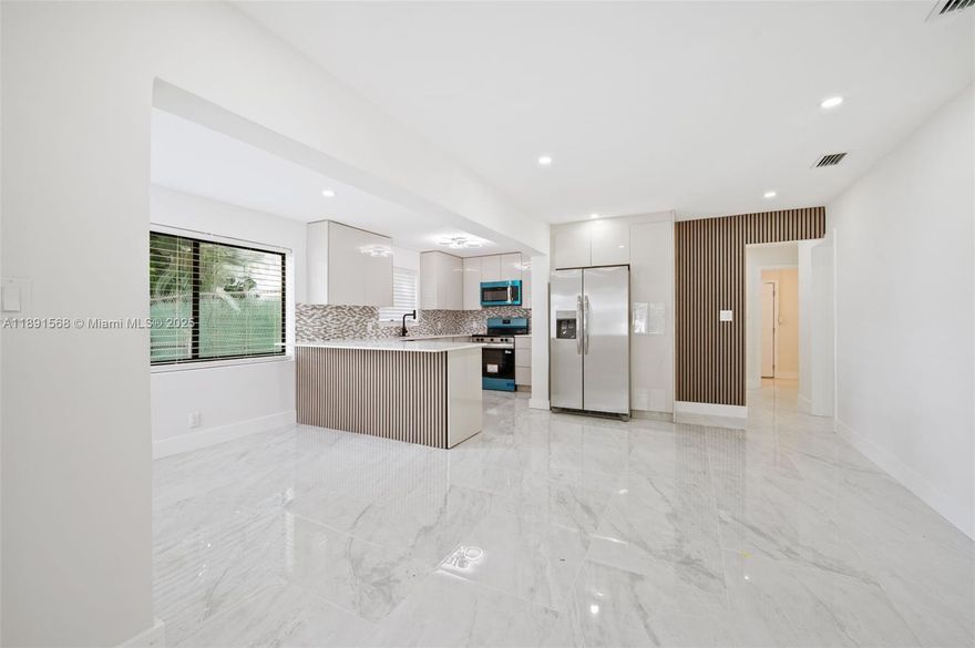 Spectacular newly remodeled cozy home with lots of features and HUGE lot of almost 16,000 sqf!!! Ready to move in and bring your toys like boat, RV, jet ski, etc. Make it your home or airbnb, close to the beach. 2025 roof, new A/C, impact windows, new European stile kitchen w/quartz countertops, SS appliances, new bathrooms, recessed lighting, tankless water heater, porcelain floors 48X24, designed doors with glass all-throughout, concrete area in backyard for pergola for parties and family gatherings.