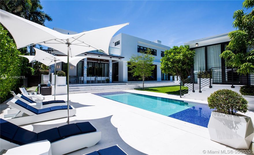 ENJOY LIVING & ENTERTAINING in this exquisite two-story 5 bed, 5.5 bath CONTEMPORARY HOME on SAN MARINO ISLAND built in 2016 complete with guest house. Interior features: large MASTER SUITE with expansive terrace & large dual walk-in closets, THEATRE ROOM, family room, den, WINE CELLAR, spacious living areas, 11ft ceilings, family friendly eat-in kitchen with double 48" SubZero Fridge & Freezer & Wolf appliances. WATER PURIFICATION throughout entire plumbing system. Exterior features: gazebo, SUMMER KITCHEN & BBQ, tropical garden with mosquito control system, HEATED OVERFLOW POOL with mosaic tile and surrounded by ShellStone. SECURITY: ADT alarm & 13-camera system along the perimeter & gates. 5 car parking + 4 car exterior parking.