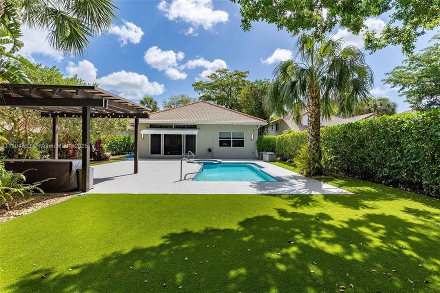 Experience luxury living in this modern 4-bedroom, 4-bath home in Palm Aire.  A Sunlit open-concept living area flows into a gourmet kitchen equipped with quartz countertops and a Wolf professional range, perfect for the avid home chef. Entertain with ease in the separate bar and family room, offering ample space for gatherings, and step outside to your private garden oasis featuring a renovated pool area and pergola—ideal for relaxing or hosting outdoor get-togethers year-round. This home is equipped with impact windows and doors for peace of mind, two AC units with smart thermostats, and electric blinds to keep you comfortable in all seasons. Set on an expansive 12,144 sq ft lot, this residence combines luxury and lifestyle in the heart of the desirable Palm Aire community.