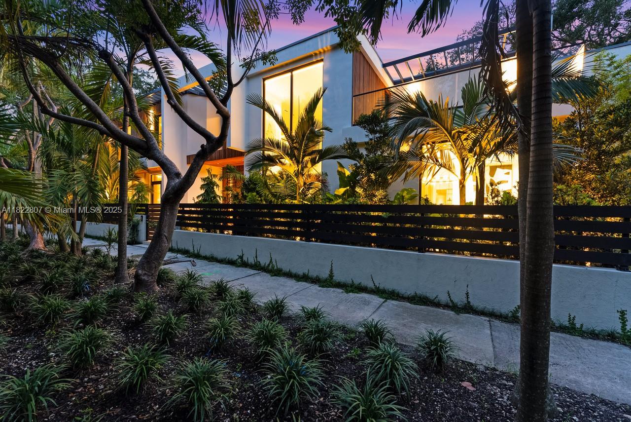 Welcome to CASA GRANDE, a striking 7BD/7BA modern residence on a premium corner lot in the heart of Coconut Grove designed by Bernardo Paredes and developed by the Modd Group. This home blends contemporary luxury with comfort and functionality. Enter through a dramatic grand foyer with a sculptural floating staircase. Main level features an expansive living room, formal dining, state-of-the-art kitchen with walk-in pantry, family room with custom millwork, home office, laundry, 2-car garage, and a serene yoga suite/cabana with full bath. Upstairs offers five ensuite bedrooms and a second-floor family lounge ideal for relaxing or movie nights. Enjoy seamless indoor-outdoor living with a covered patio, summer kitchen, resort-style pool, spa, and lush tropical landscaping.