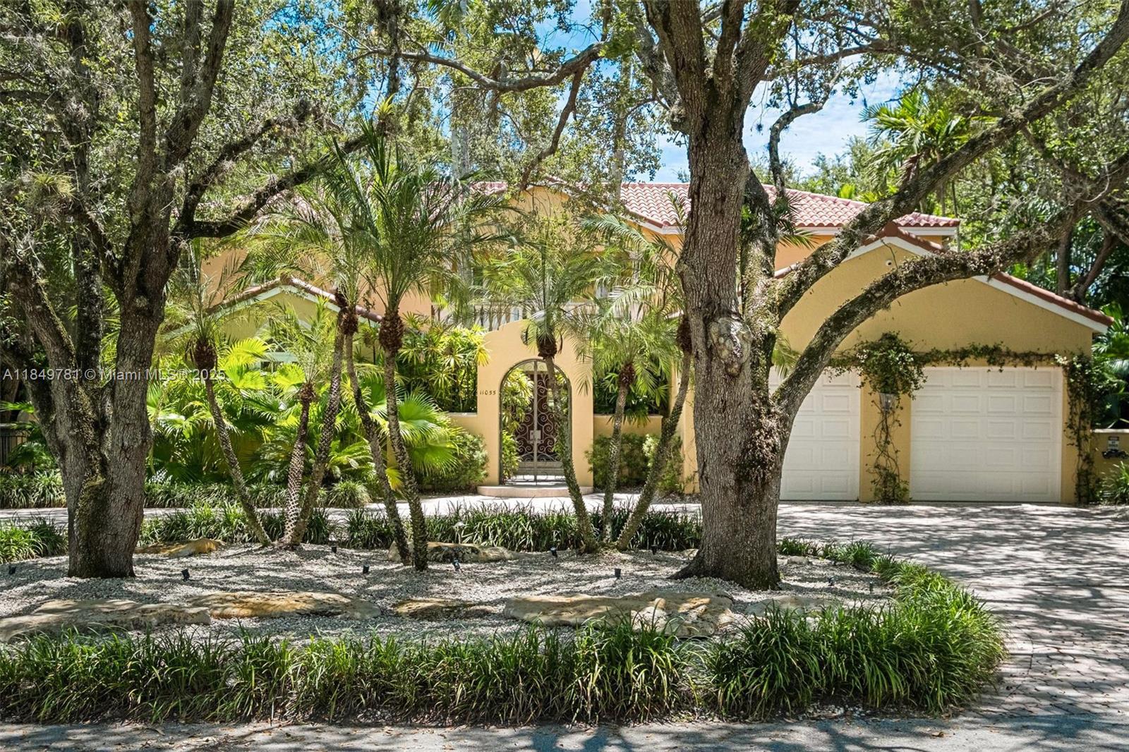 Graceful S. Gables home on quiet cul-de-sac in coveted Fairchild Oaks, just off historic Old Cutler Rd blends comfort & ease of living w/ chic Miami style & tropical European grandeur. Moments from Fairchild Tropical Garden and Matheson Hammock! Filled w/ natural light & views of mature majestic oak trees lining the property, it offers 5 bdrms, one doubles as an office, relatable casual & formal living spaces, oversized eat-in kitchen w/ views into the backyard, private upstairs primary w/ herringbone wood floors, tasteful built-ins, & generous bath. Addtl highlights: 2025 roof, impact windows/doors, 2-car garage w/ epoxy floor & built-in cabinetry, Generac generator, gas fireplace, tankless water heaters, security cameras, built-in sound system, low maintenance turf, & timeless finishes.