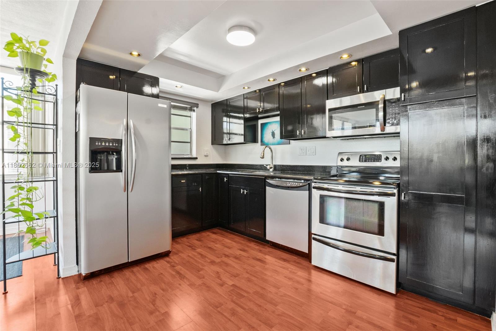 Beautifully updated 2BD/2BA corner unit in one of Hollywood's most charming and centrally located communities! This spacious residence boasts an open concept layout w/a large kitchen featuring freshly painted modern cabinets, stainless steel app and gorgeous vinyl flooring throughout. The master bedroom. offers a generous walk-in closet, and the screened balcony provides a perfect spot to relax. Enjoy resort-style amenities 2 heated pools, tennis court, dockage, fitness center, sauna, clubhouse w/ billiards, party room with water views, BBQ area, Includes 1 assigned pkg space & guest parking. Basic cable included. W/D on each floor. Unbeatable location near I-95, US-1, 595, FLL Airport, Hollywood, shops & restaurants. Just minutes to Hollywood Bch and the Yellow & Green Market. Call today!
