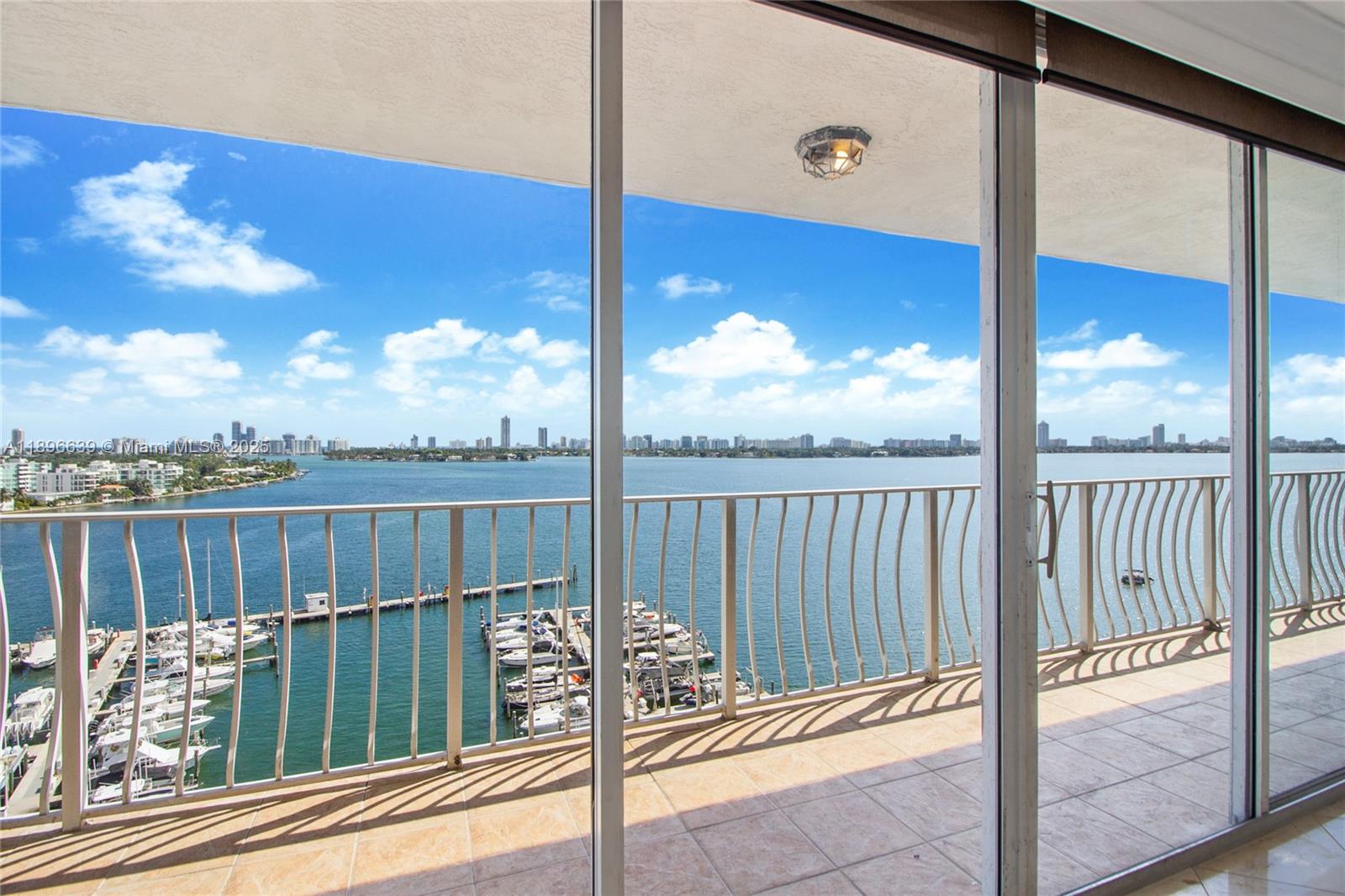 Experience breathtaking panoramic views of Biscayne Bay and the Miami Beach skyline from every room in this bright and spacious 2-bedroom, 2-bath residence at Grandview Palace. Enjoy floor-to-ceiling windows, an oversized balcony with direct east exposure, and an open split floor plan ideal for privacy and entertaining. The primary suite features a walk-in closet and ensuite bath. The unit includes two assigned garage parking spaces in a convenient location on the ground floor and close to the entrance.  Grandview Palace offers a bayfront pool, marina, shops, café, and 24-hour security—all in the heart of North Bay Village, just minutes to Miami Beach, Midtown, and Bal Harbour. Wake up every day to postcard-perfect water views!