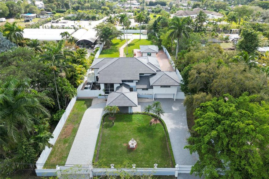 **NEW ROOF & Fresh Outdoor Paint** A luxurious oasis in Horse Country Estate on a full acre lot of paradise. An amazing entry into a Porte-Cochere as drive up a circular driveway. The front double doors lead you to the relaxing sound of water falling down a stone pond. Home has 8 bedrooms and 5 full bathrooms in main house, 2 car garage, office, recreational room, marble floor throughout the first floor. It has a beautiful wraparound covered terrace overlooking the pool and tennis court. The Guest House/In-Laws has 2 bedrooms and 1 full bathroom. Also having its own covered area. New roof added dec 2024. all a/c new from 2021 present.