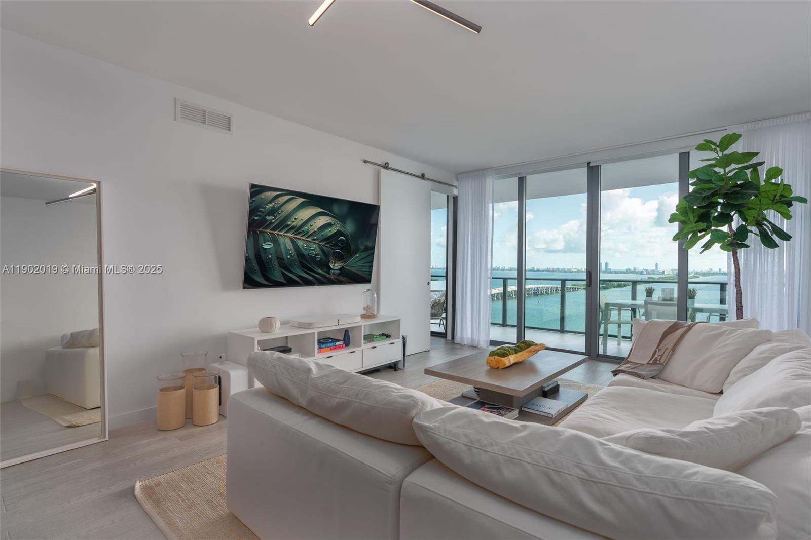 Enjoy breathtaking panoramic views of Biscayne Bay and Miami's skyline from this large luxurious unit in the iconic new waterfront development at One Paraiso Condo by renowned designer Piero Lissoni. Unit features1BD+Den/1.5BA, 959sf, private elevator & foyer, 9ft ceiling windows, electric blackout shades, Sub-Zero & Wolf appliances. State-of-the-art amenities: tennis & basketball courts, sunrise & sunset pools, jacuzzi, beach club, gym, spinning room, spa, sauna, steam room, movie theater, kids indoor playroom, boat dock, Amara Restaurant by famous chef Michael Schwartz, and more... FURNITURE AVAILABLE FOR PURCHASE AT ADDITIONAL COST
