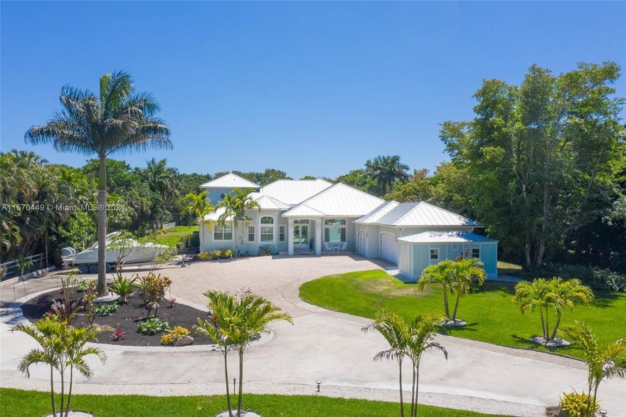 Nestled within the picturesque landscapes of SW Ranches, this captivating estate offers the epitome of casual elegance gracefully situated on over 2 acres of lush Tropical grounds. Immaculate Home built in 2016 state-of-the-art kitchen, high end Thermador appliances, gas range, & expansive center island; perfect for culinary enthusiasts. Desirable open floor plan & high ceilings where natural light dances through expansive Impact windows, highlights the seamless flow to the outdoor oasis. Relax & enjoy the resort style pool, magnificent summer kitchen & covered patio area, ideal for alfresco dining. Embracing the charm of its surroundings, this home offers a serene retreat while maintaining close proximity to urban conveniences; a rare opportunity to experience the best of both worlds.