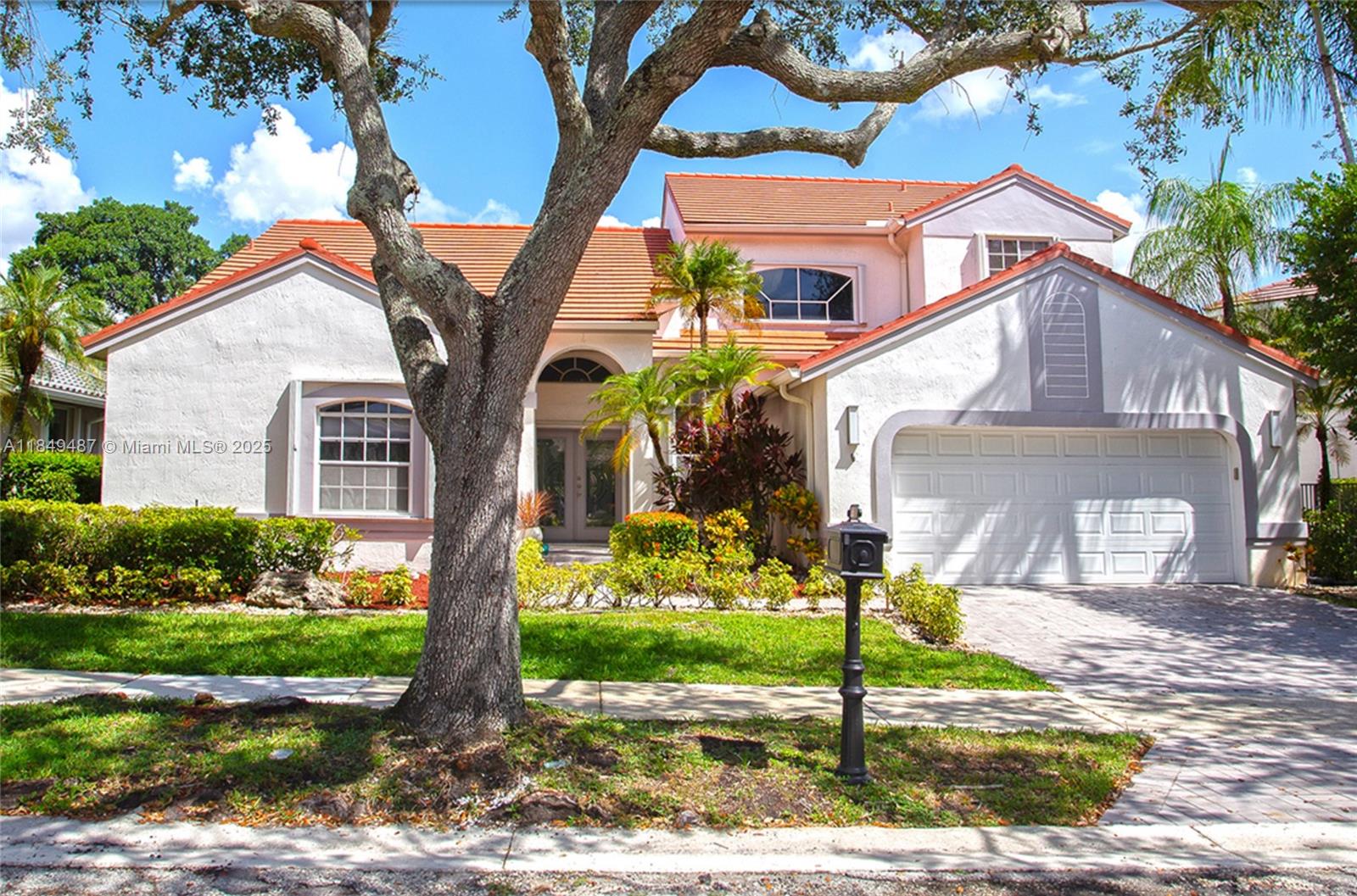 Elegant two-story home located in the prestigious Weston Hills community, featuring a south-facing front and a north-facing backyard. Soaring ceilings, French doors, large windows, and neutral tile flooring that add light. Two bedrooms are conveniently located downstairs, including a spacious primary suite with direct patio access. Upstairs, find two more bedrooms and a versatile loft perfect for an office, studio, or fifth bedroom. Roof replaced in 2018, A/C is 9 years old, and water heater is newer. The backyard is a private oasis surrounded by lush landscaping, no rear neighbors, and no golf traffic. Beautiful pool in a true resort-style setting. Ideal to personalize.