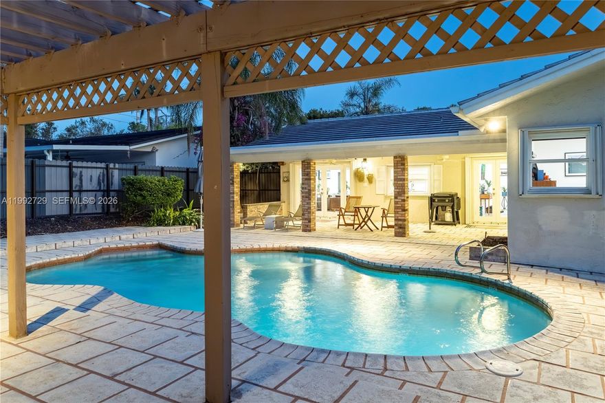 Beautiful 3-bedroom, 2-bathroom single-family home with a pool located in the highly sought-after Cherry Grove neighborhood, surrounded by multi-million-dollar properties. The home features elegant tile flooring throughout, creating a clean and cohesive feel. Filled with natural light, it offers an updated kitchen with white quartz countertops and stainless steel appliances, along with spa-like bathrooms featuring dual sinks. A gated courtyard entrance leads to a private, lush backyard with a sparkling pool, ideal for entertaining or relaxing in complete privacy. Conveniently located with easy access to highways 826, 874, and 878, just minutes from Dadeland Mall, Baptist Hospital, US1, and within walking distance to Sports Grill, Kendall Library, and Cherry Grove Park.