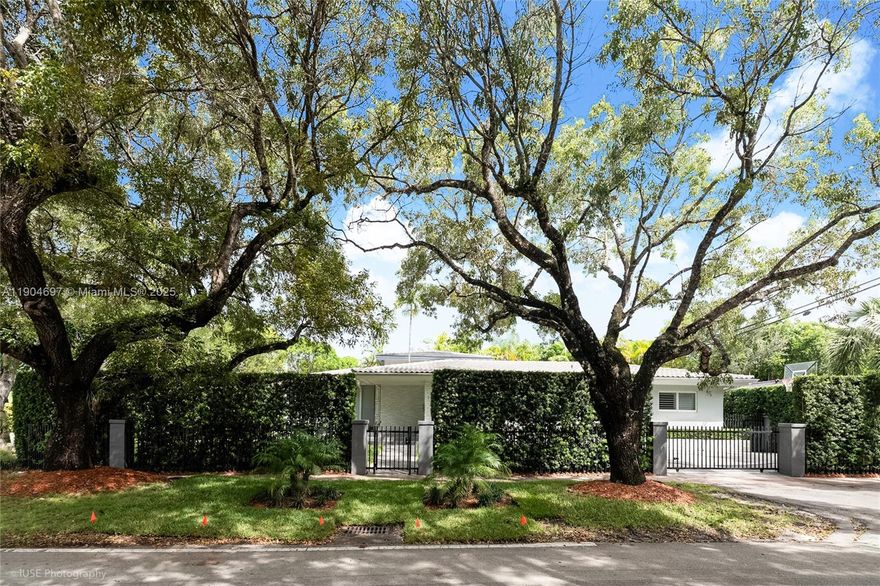 Set on a picturesque tree-lined street, this beautifully remodeled CORNER residence in the heart of Coral Gables offers both timeless charm and exceptional privacy. Surrounded by a lush wraparound hedging fence, the 3 bedroom, 2.5-bathroom home provides a serene retreat with modern upgrades throughout. The property also offers generous, secure, gated parking, enhancing both privacy and convenience. The remodeled kitchen features quartz countertops and stainless-steel appliances, complemented by refinished original wood floors and updated bathrooms. Ideally located near Downtown Coral Gables, South Miami, and the University of Miami, this move-in ready residence perfectly balances elegance, comfort, and convenience.