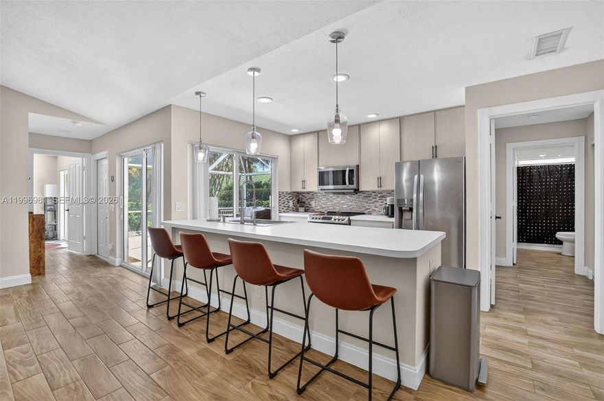 Light, bright, updated, and move-in ready villa with soaring ceilings in Lake Catherine awaits! The open concept living space is perfect for entertaining while the split floorplan offers privacy. Wood-look tile floors run continuously throughout and impact sliding glass doors offer private access to your spacious lanai from every room. No polybutylene pipes here! The association fee covers roof repairs and exterior insurance. If you are looking for a tranquil oasis in a convenient location, this one checks all of the boxes. Walkable to parks and restaurants, close to I-95 for your daily commute and a short drive to the beach for weekend relaxation.