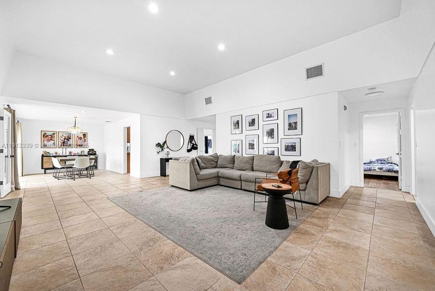 Nestled in the sought-after Emerald Hills neighborhood, this home offers a generous layout across more than 2,700 square feet. Space to make 2 additional bedrooms! The home boasts a massive living area, a formal dining room, and spacious bedrooms with ample storage, including a walk-in closet. Recently updated, the kitchen and bathrooms bring modern convenience to this inviting residence. Two screened-in patios provide serene views of the lush backyard—ideal for hosting or unwinding. Prime location just steps from houses of worship, local shops, parks, and the community pool. This home blends elegance, comfort, and convenience in one perfect package.