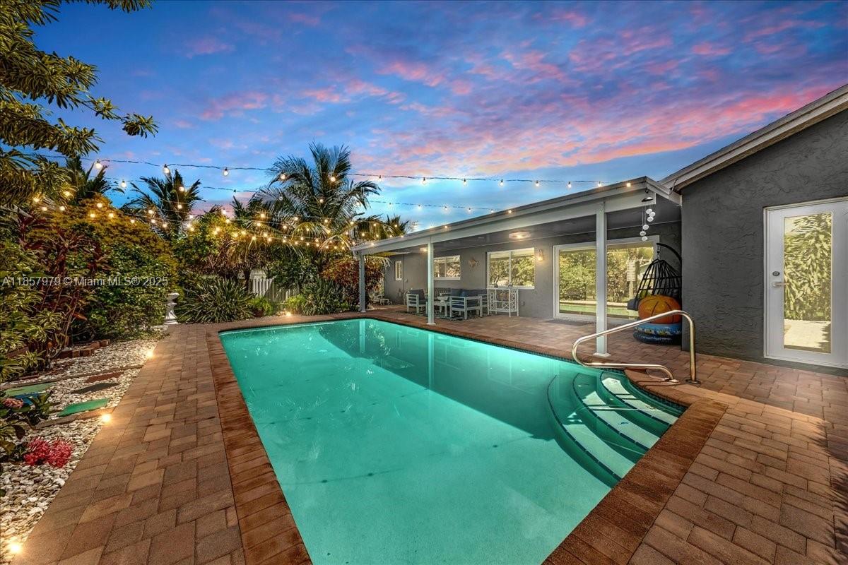Stunning 3 bed2, 2 baths, 2 car garage waterfront corner lot home pool, fully updated and ready to move in! Step into a sun-filled interior with vaulted ceilings, French doors, neutral finishes, and sliding windows framing serene views. The backyard is a true tropical retreat, sparkling pool, tiki hut, covered patio, and abundant fruit trees for your own harvest. Impact doors/windows and a privacy fence add peace of mind. Ideally located minutes from Sawgrass Mills Mall, BB&T Center, Markham Park, and top-rated medical facilities and schools. Quick access to I-595 and the Sawgrass Expressway makes commuting a breeze. A perfect mix of style, comfort, and Florida outdoor living!