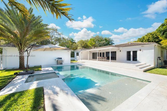 Completely renovated and located in the heart of Miami Shores, this beautiful home offers comfort, style, and smart features. The open-concept layout includes an oversized island and sliding glass doors that lead to a covered patio and private pool, perfect for relaxing or entertaining. The split-bedroom design provides a spacious master suite for added privacy. Enjoy clean, filtered water from a full-house water filtration system. Smart home features include a Ring video doorbell, Ring security cameras, Nest thermostats, smart lock, and Ring smoke/CO2 detectors. Detached two-car garage included. Rent covers landscaping and pest control for a worry-free experience.