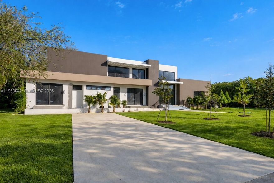 Nestled in the heart of Pinecrest, this brand-new construction residence sits on an expansive builder’s acre lot and features volume ceilings with floor-to-ceiling windows that flood the open-concept interiors with natural light. Designed for both everyday living and entertaining, the home offers 6 bedrooms and 7.5 bathrooms, formal dining, and a thoughtfully appointed wet bar. The kitchen is equipped with subzero and wolf appliances, Italian cabinetry, and custom built-ins. Additional highlights include a flexible room with en-suite bath, guest accommodations, cabana bath, elevator, concrete roof, three-car garage, covered terraces, and a summer kitchen is seamlessly integrated with the outdoor living areas and pool.