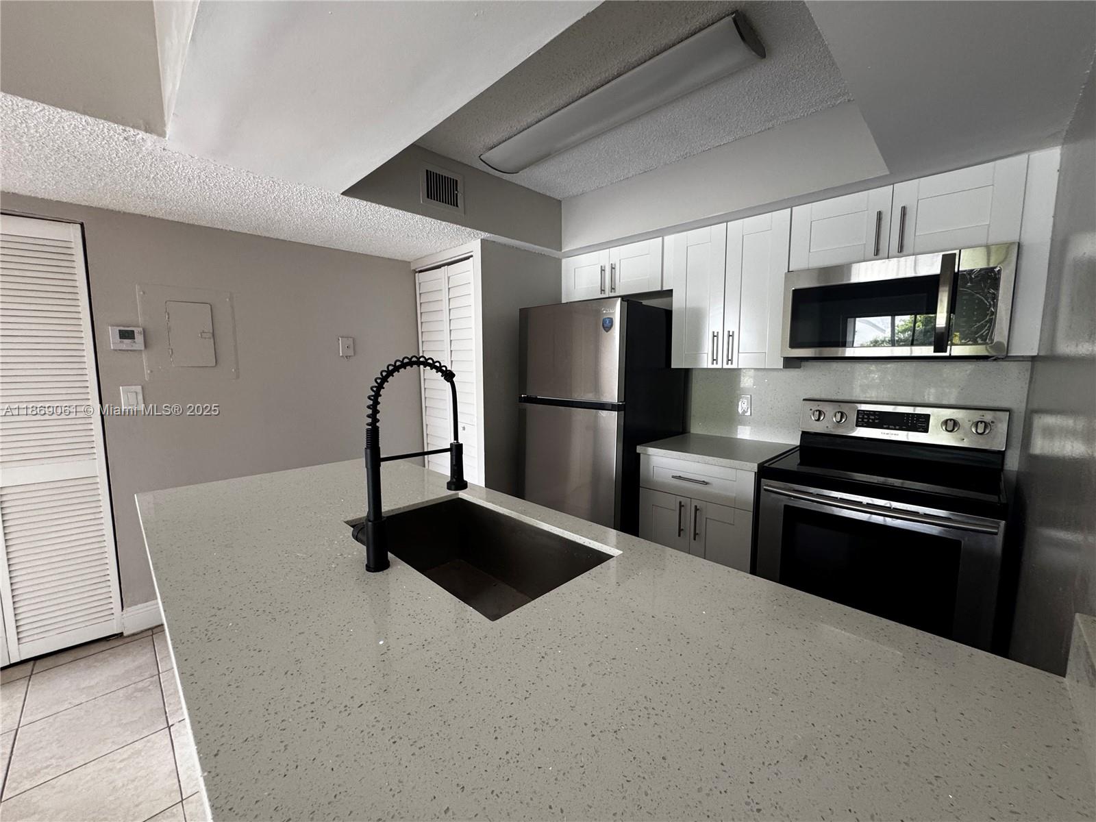 Completely Updated Unit!! All Ages Welcome! Immediate move-in available!!! No association approval required!!! Quiet and safe living in the gated community of Sun Vista Gardens. Unit features Brand New Kitchen, Brand New Bathroom, Fresh Paint, high vaulted ceilings, private in-unit laundry with in-unit washer and dryer, tile flooring throughout, central A/C, walk-in closet, screened balcony with extra storage room. Enjoy this beautiful gated community with amenities that include, Volley ball court, pool with hot tub, fitness center, Tennis Courts, elegant clubhouse lounge and much more. Conveniently located less than a 1/4 mile from the turnpike on Commercial Blvd. and Rock Island Rd... Call today while still available. Driving Directions: