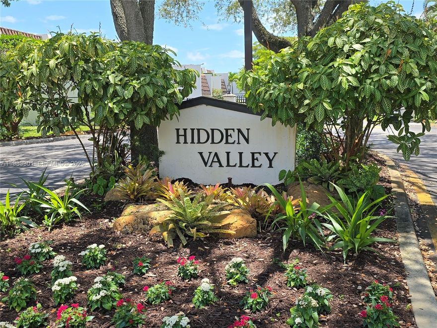 Hidden Valley, Miami's best kept secret; A gated community of 100 townhouses set upon former golf course. This spacious corner 2 bed   2 1/2 bath townhouse is tiled throughout.  1780 sq ft under air, but this unit provides multiple additional living spaces with  a front, rear and upper deck/patio.  Impact windows with lovely side  bay window provide good natural lighting and protection. 2nd floor features dual enormous primary bedrooms and your laundry closet. Entry level is the Kitchen with top of the line appliances and a combined living /dining area and 1/2 bath for guests and convenience. . Wonderful views from every room. Freshly painted both inside and out.  Community amenities include lighted tennis courts, pool*, and 1/2 mile walking path. Minutes to all major Hospitals, Universities, MIA and access to all major expressways. A great deal** and a must see.