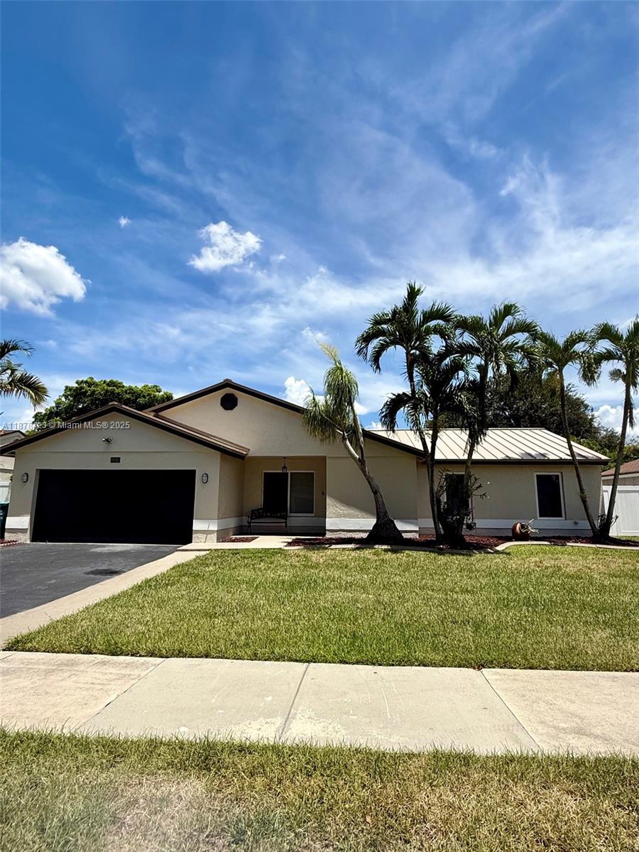 Beautifully updated home featuring new flooring, renovated bathrooms, new roof, impact windows, and laundry area. Electric car charging station included! Located in a desirable neighborhood with top-rated schools, close to parks, dining, and highways. Lawncare and pest control included. Move-in ready, fast approval and NO HOA!