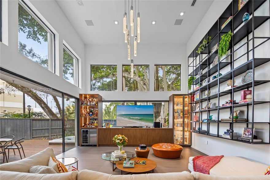 Discover a rare opportunity to live in the gated enclave of Kumquat Village, nestled in the heart of South Coconut Grove. One of just ten homes surrounded by lush tropical landscaping and majestic oak trees, this exquisite two-story single-family residence has been meticulously remodeled and thoughtfully designed.

The home features a brand-new roof and a dramatic floor-to-ceiling glass wall that fills the interiors with natural light, creating a warm and inviting ambiance. The kitchen flows seamlessly into the dining area and showcases a leather-finished onyx countertop, stainless steel appliances, and soft-close cabinetry.

Step outside to a private terrace perfect for relaxing or enjoying al fresco dining, complemented by a jacuzzi and a fully fenced yard with a low-maintenance design and sprinkler system, ensuring both ease of upkeep and year-round greenery.

Don’t miss the opportunity to make this exceptional property your home