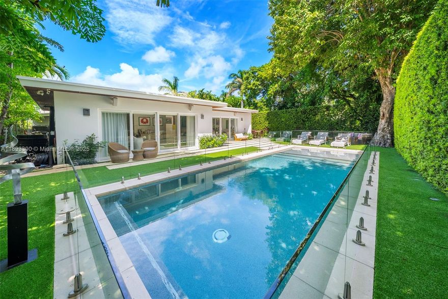 This exquisitely decorated 4-bedroom, 4.5-bathroom home on prestigious North Bay Road combines elegance, style, and functionality. Bright and uplifting, the thoughtfully designed one-level layout opens seamlessly to a backyard oasis, featuring a sparkling pool with a sleek glass fence, perfect for entertaining or relaxing in sophisticated comfort. Featuring three separate wings, each bedroom has a private bathroom and custom closets. Soaring ceilings, impact windows, and designer finishes enhance every corner, while the chef’s kitchen, equipped with a gas stove, Sub-Zero appliances, and a pantry, is ideal for gatherings. Additional features include impact-resistant windows and an integrated sound system, making this Miami Beach residence as practical as it is beautiful.