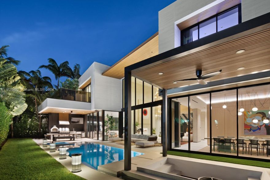 Step Inside With Me! Conceived by leading minds in architecture and design, this ultimate Bal Harbour home is offered furnished. 23’ ceilings reveal a grand salon illuminated by oak paneled walls, adorned by picturesque glass doors, and custom drapery. Outfitted in fluted travertine, the culinary experience is complete with a stylish breakfast nook, TV room and open vapor fireplace. The stunning dining room is defined by green marble & diamond wood flooring, seamlessly framing a 16-seat statement table. Parisian-style suede walls, floating nightstands, a calacatta violetta bath, & showroom dressing suite highlight the primary wing. Revel in the outdoors at the sunken fire pit, cabana, and stylish pool setting.  Located in a truly gated community within close proximity to a private marina.