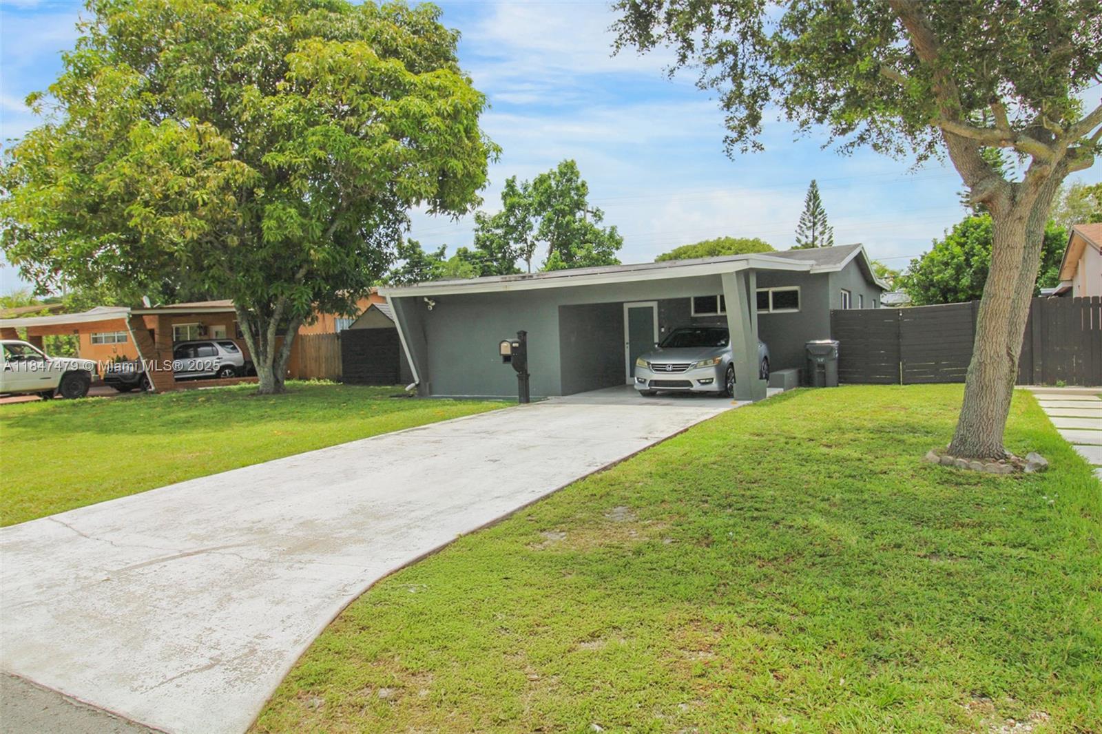 Modern, warm, and inviting 5 BR, 2 Bath home blending comfort, functionality, and income potential. Features an open floor plan with upgrades including a remodeled kitchen with energy-efficient stainless steel appliances, quartzite countertops, and contemporary cabinets. Both bathrooms are updated with a modern style. High-impact windows, a new roof (2018), and updated plumbing (2016) ensure durability. Vinyl flooring, fresh paint inside and out, and a versatile bedroom/laundry space offer convenience. The large backyard is perfect for a pool or outdoor kitchen, with a shed, and the expanded front yard has a mango tree. Covered carport and wide driveway provide ample parking. Schedule your showing today!