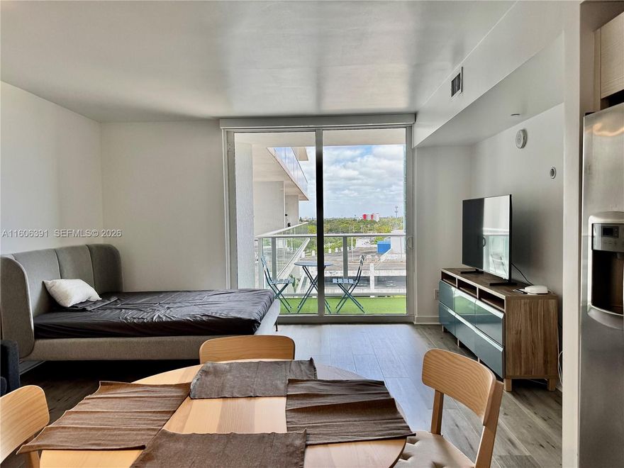 Experience modern Miami living in this spacious studio at Baltus House, a boutique building offering luxurious amenities and stunning Biscayne Bay views. The unit features floor-to-ceiling windows, stainless steel appliances, and an in-unit washer/dryer. Enjoy resort-style perks, including a pool, spa, sauna, rooftop terrace with BBQs, and an exercise room. With free guest parking, secure entry, and 24/7 security, your peace of mind is ensured. Located just blocks from I-95 and walking distance to the Miami Design District, Midtown, and Wynwood, with quick access to Miami Beach and Edgewater. Includes one assigned parking spot.