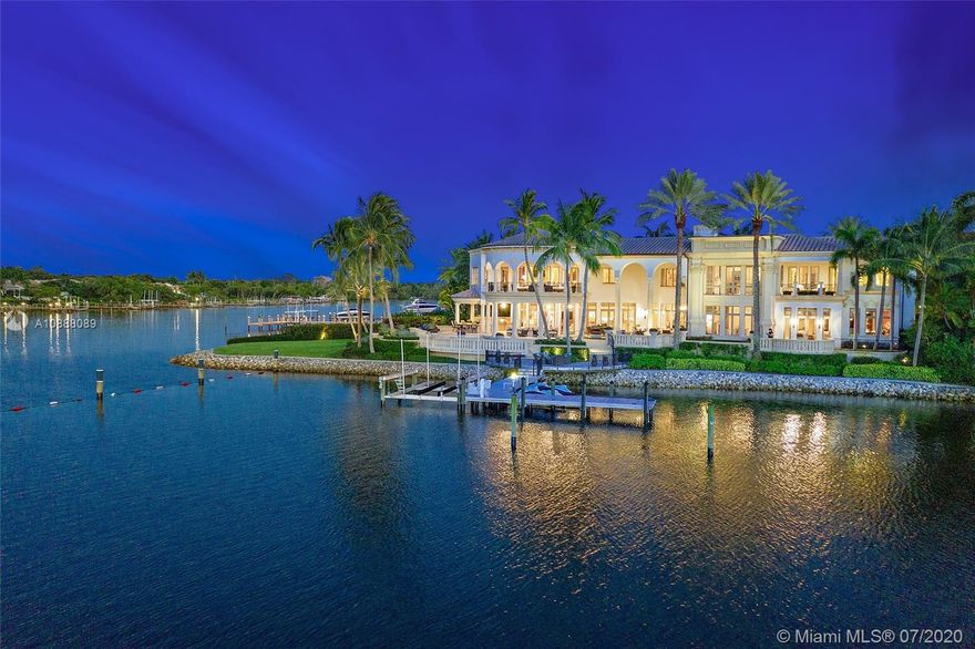 This stunning 5 BR, 7.1 BA Admirals Cove estate sits on over 220' of panoramic water frontage. The ultra-desirable Intracoastal point lot is situated on water on two sides of the property with a protected dock for a large yacht. The property boasts state-of-the-art amenities including a gourmet chef's kitchen, club room overlooking the water way, elevator, private guest suites, 3.5 car garage, impact windows and doors and generator. The unrivaled craftsmanship and exquisite details are prominent among the custom ceilings, stone floors, and sweeping majestic stairway. The Master Suite has his and hers closets and baths, wide water views and private balcony. The luxurious outdoor areas perfectly epitomize the ultimate Florida lifestyle with the privacy of your own tranquil oasis.