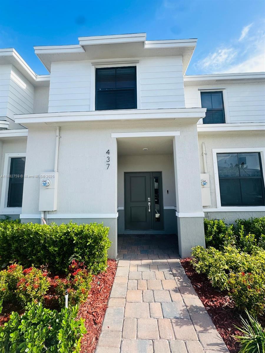 Discover spacious and modern living at 437 NE 13th St, Florida City, FL 33034, in this stunning 3-bedroom, 3-bathroom townhouse located in the desirable Palm Cay community. This beautifully designed home features a bright, open-concept kitchen, dining, and living area—perfect for both everyday living and entertaining. Enjoy elegant tile flooring in the main areas and plush carpet in the bedrooms. Step outside to a private, fenced-in lakefront patio that offers serene water views and a perfect setting for outdoor relaxation or gatherings.