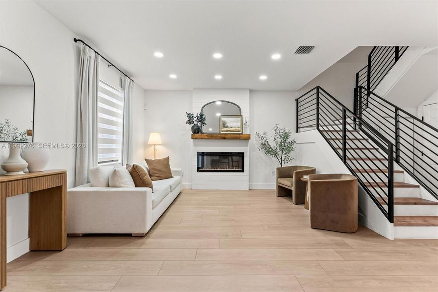 OPEN HOUSE WEDS 5-7PM GATE CODE 47271| Step into DESIGNER-UPGRADED living in one of Aquabella’s most striking townhomes currently available, where every finish and detail was thoughtfully picked! This elegantly remodeled 3-bed, 2.5-bath townhome is move-in ready, featuring fresh interior paint, hurricane impact doors, modern wood flooring throughout with no carpet, a custom modern stair railing, recessed lighting, zebra blinds, & an upgraded first-floor powder room. A stunning built-in fireplace wall unit welcomes you and sets the tone for the warm, open-concept living space. The living & dining area flows into a stunning kitchen with high-end two-tone cabinetry and upgraded Frigidaire Gallery appliances, plus an additional family room. West-facing exposure fills the home with natural light throughout the day! Enjoy a private oversized patio finished with artificial turf. The generously sized primary suite offers a comfortable retreat, while both the primary & second bedrooms feature large walk-in closets. All rooms are fit with custom built-ins closets. Additional features include: water filtration system, washer/dryer, Ring door camera/alarm system, & AT&T internet is included with the HOA. Two assigned parking spaces plus guest parking conveniently located across the home. Resort-style amenities include 2 clubhouses, pools, gyms, splash zone, parks, gated entrances & year-round community events. This is a fee simple townhome w/ flexible financing including 3.5% or 5% down.