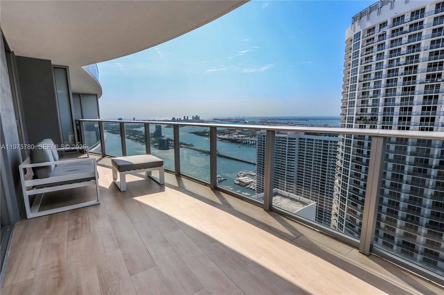Enjoy breathtaking bay and city views from this modern furnished 1 bed/1.5 bath at Aria On The Bay. Unit features a spacious walk-in closet, washer/dryer in unit, 1/2 bath for visitors, and a large balcony overlooking the bay and city. Offered Furnished. Located directly across from Margaret Pace Park, surrounded by cafes/restaurants, Publix, performing arts center, etc. Easy access to Miami Beach, Design District, Wynwood, Midtown, and Brickell. Aria's amenities include 2 pools, spa, state of the art gym and yoga studio, BBQ area, conference rooms, movie theater, kids playroom and more. Building requires additional $2,000 security deposit to be paid by Tenant directly to Aria on the Bay. Available April 1, 2026.