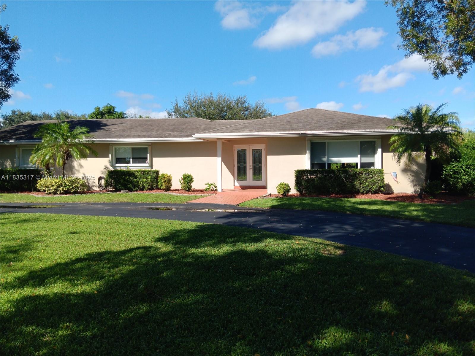 This great pool home in Davie is situated on a builder's acre in a private cul-de-sac. It features 3 bedrooms and 2 full bathrooms, a master bath with a frameless shower and a walk-in closet. This home offers porcelain tile flooring throughout. The updated kitchen boasts quartz countertops, a breakfast bar, and stainless steel appliances, and it seamlessly opens to both the living room and the family room. The spacious backyard includes a large stone paver deck and a covered patio surrounding a newly refinished free-form pool, all within a fully fenced yard. For added safety, the home is equipped with hurricane protection for all windows and doors. Conveniently located, this property is close to a variety of parks, dining, and entertainment options, and it lies within an A+ school district