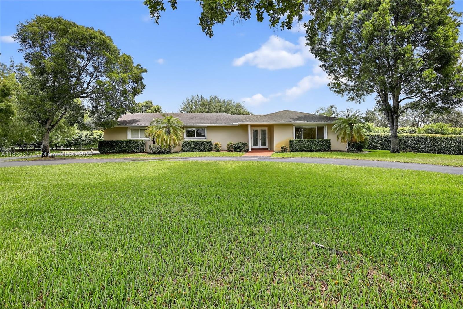 This great pool home in Davie is situated on a builder's acre in a private cul-de-sac. It features 3 bedrooms and 2 full bathrooms, a master bath with a frameless shower and a walk-in closet. This home offers porcelain tile flooring throughout. The updated kitchen boasts quartz countertops, a breakfast bar, and stainless steel appliances, and it seamlessly opens to both the living room and the family room. The spacious backyard includes a large stone paver deck and a covered patio surrounding a newly refinished free-form pool, all within a fully fenced yard. For added safety, the home is equipped with hurricane protection for all windows and doors. Conveniently located, this property is close to a variety of parks, dining, and entertainment options, and it lies within an A+ school district