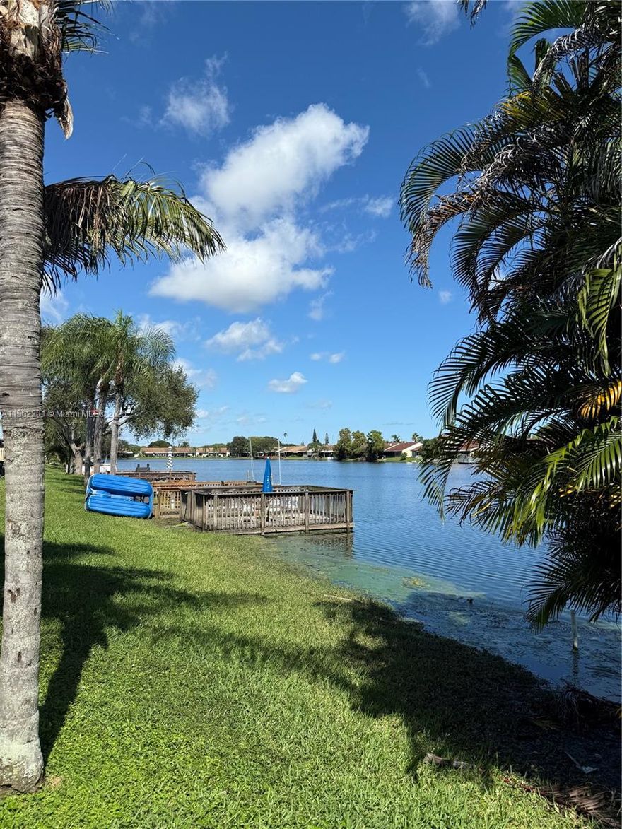 This updated, fully furnished,  2-bedroom, 2-bathroom, lakefront villa is located in a prime Hollywood location, offering a tranquil yet convenient living experience. The home has been beautifully renovated, featuring a modern kitchen with glossy, white cabinetry, stainless steel appliances plus an additional countertop and plenty cabinetry for storage. The villa has a glass enclosed patio with stunning views of the lake, making it perfect for relaxing and entertaining.