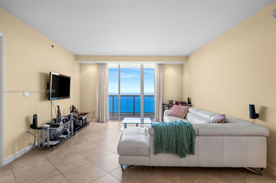 This luxurious beachfront unit features two bedrooms plus a den, which can be converted into a third bedroom or office, along with three full baths. The spacious layout includes walk-in closets and a gourmet kitchen equipped with KitchenAid appliances. The master bath provides a spa-like experience, complete with a Jacuzzi tub, dual sinks, a separate shower, and a bidet. Residents can enjoy fantastic amenities, including three heated pools, a spa, 24-hour valet and security services, and a 28,000 sq ft fitness center with stunning ocean views.