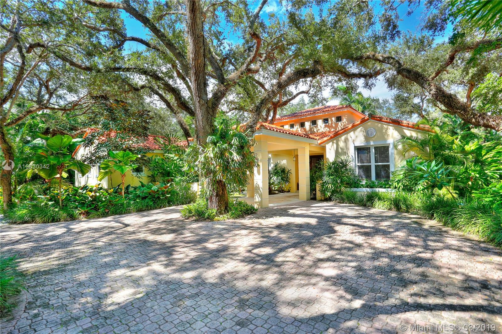 Absolutely beautiful home on private tree lined street in South Gables. This 5 bedroom, 6 bathroom home has been exquisitely updated including a newly enclosed family room, new gourmet kitchen, new master bathroom, full house generator, and impact glass windows and doors.  Magnificent oaks and lush landscaping welcome you into this gated property and fabulous one story house with center great room with vaulted ceilings.  Generous rooms and split plan make this home so wonderfully livable! The backyard features a newly resurfaced pool, covered patio and outdoor summer kitchen with cabana bath, all on the most private 27,000+ square foot lot. 2 car garage, laundry room, gym, and Pinecrest Elementary!