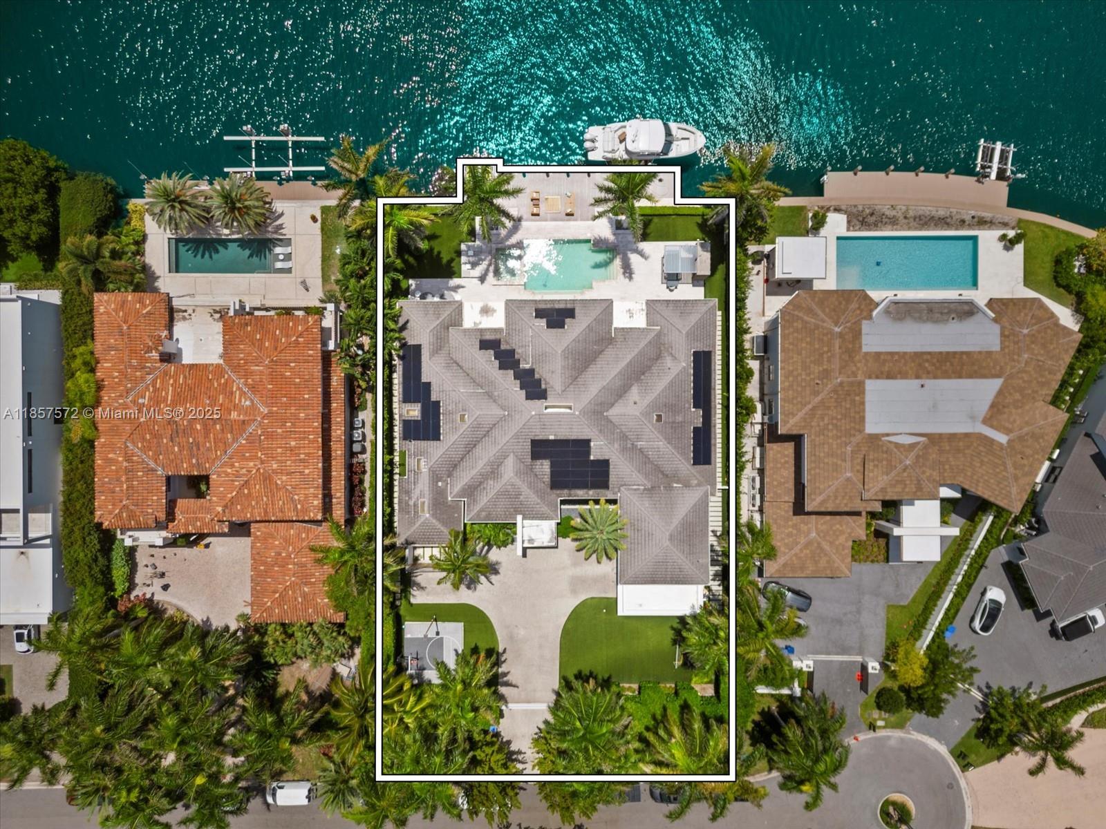 Welcome to your dream home in Golden Beach's exclusive South Island! This unique turnkey one-story residence, set on an oversized 18,975 sqft lot, features a spacious open floor plan with soaring 16 ft ceilings. Revel in stunning waterfront living with 115 ft on the water, complete with a newly built boat lift and a yacht and jet ski-equipped dock. The home boasts 6 luxurious suite bedrooms, including an oversized master suite with an outside Bali-style bathroom, a gym, and a second-floor in-law's or a teenager's dream unit . The manicured resort-like outdoor space is perfect for entertaining. Decorated to perfection and designed for the ultimate entertainer, this custom masterpiece offers unmatched amenities and is one of the most unique and desirable properties in the neighborhood.