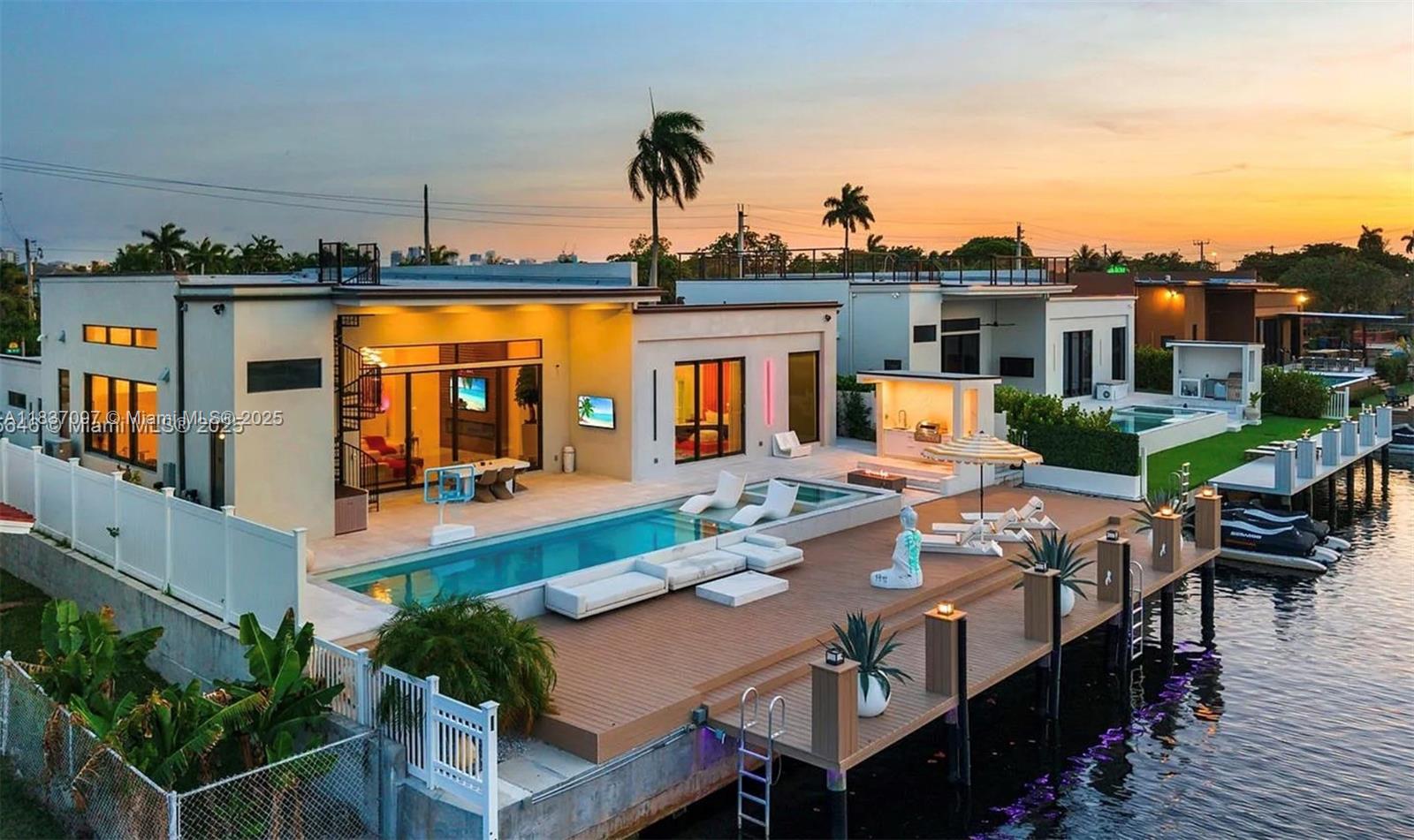 This stunning 4-bedroom, 3-bathroom waterfront home blends modern luxury with sleek, high-end design in the exclusive gated community of Bal Harbour. The home features soaring 16-foot vaulted ceilings, floor-to-ceiling windows and doors, and over 3,000 square feet of open-concept living space.
Enjoy 80 feet of direct ocean-access frontage on the Middle River with a seawall and private dock. The resort-style backyard is an entertainer’s dream, featuring a California summer kitchen, heated pool, jacuzzi, and stunning water views.
Located less than a mile from Fort Lauderdale Beach and the Galleria Mall, and under 3 miles to Las Olas Blvd’s famous dining and shops. Walk to Whole Foods, Trader Joe’s, and more. This is coastal luxury living at its finest.